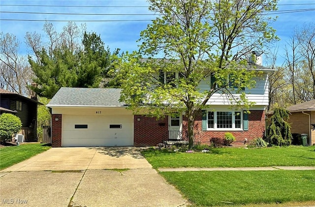 traditional-style home with an attached garage, concrete driveway, a front lawn, and brick siding