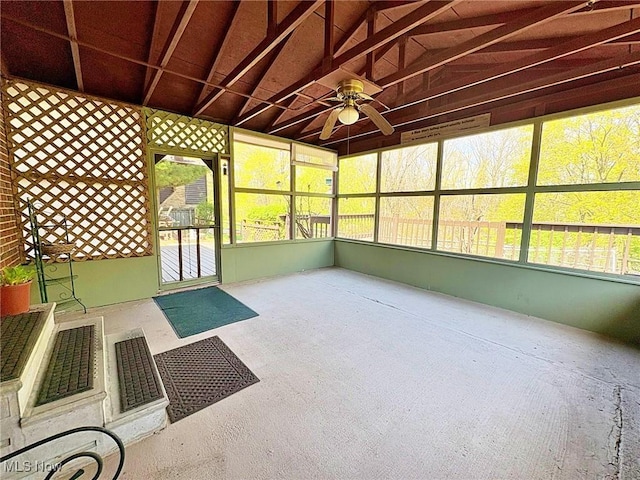 unfurnished sunroom with a ceiling fan and a wealth of natural light