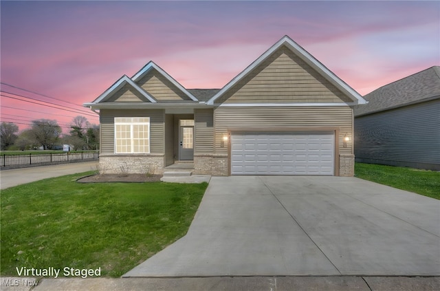 view of front of property featuring an attached garage, a front lawn, fence, and concrete driveway