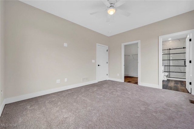 unfurnished bedroom with a ceiling fan, visible vents, carpet floors, baseboards, and a spacious closet