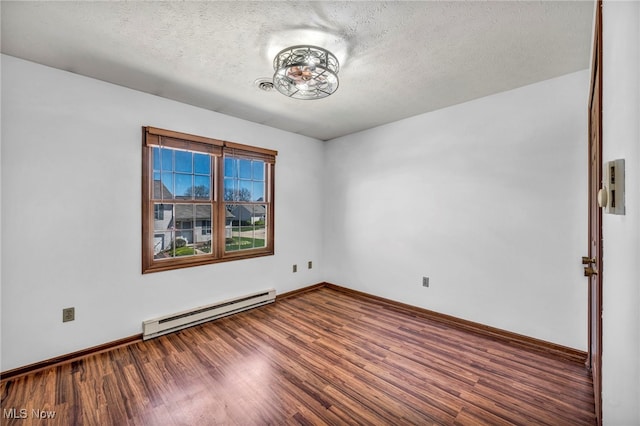 spare room with baseboards, a baseboard radiator, a textured ceiling, and wood finished floors