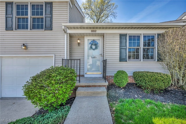 view of exterior entry with a garage