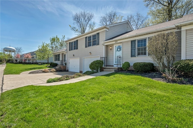 tri-level home with an attached garage, driveway, and a front lawn
