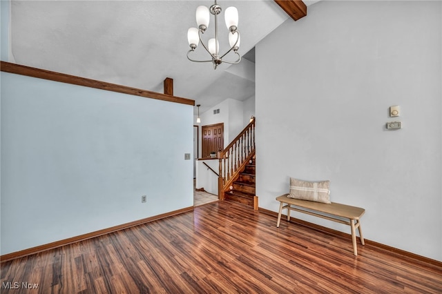 interior space with stairs, high vaulted ceiling, an inviting chandelier, and wood finished floors