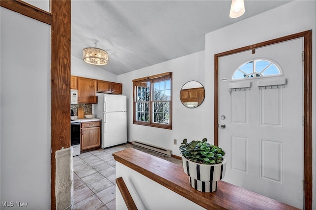 foyer entrance featuring baseboard heating, light tile patterned flooring, a textured ceiling, and lofted ceiling