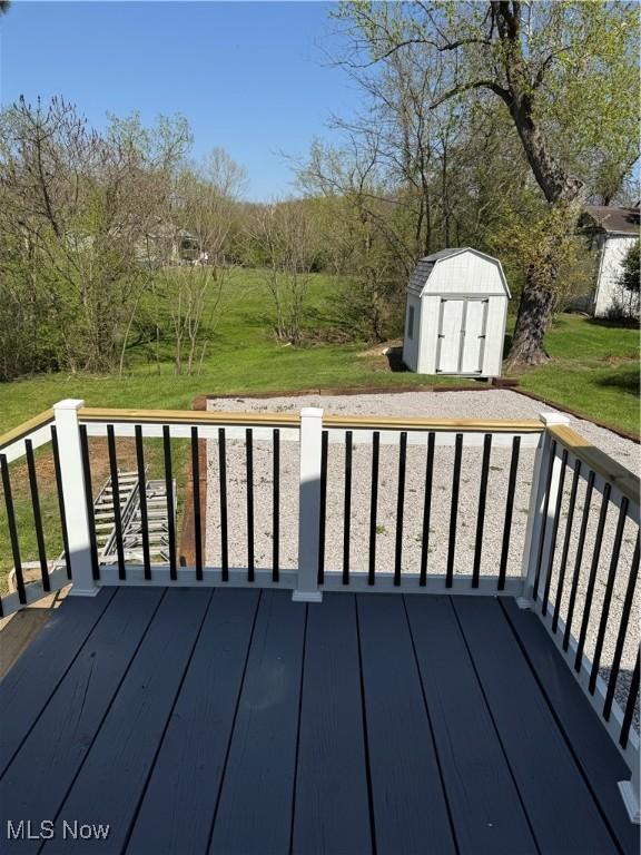 3607 Camden Ave, Parkersburg, WV 26101 - wooden deck featuring an outdoor structure, a lawn, and a shed