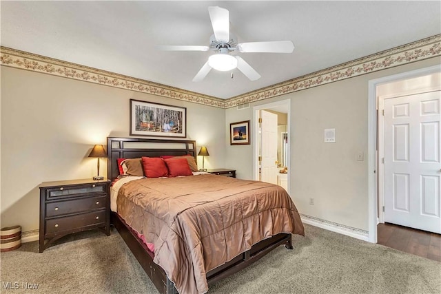 carpeted bedroom featuring baseboards, a ceiling fan, and ensuite bath