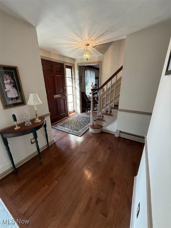 422 Glenwoods Ct, Boardman, OH 44512 - foyer entrance with baseboard heating, wood finished floors, stairway, and baseboards