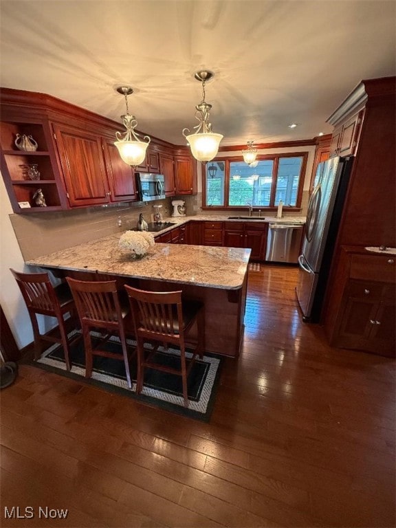 422 Glenwoods Ct, Boardman, OH 44512 - kitchen featuring stainless steel appliances, a peninsula, a sink, dark wood finished floors, and light stone counters