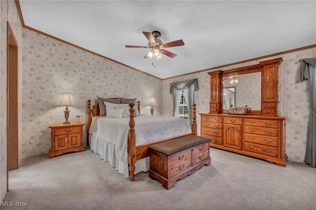 bedroom with crown molding, ceiling fan, light carpet, wallpapered walls, and lofted ceiling