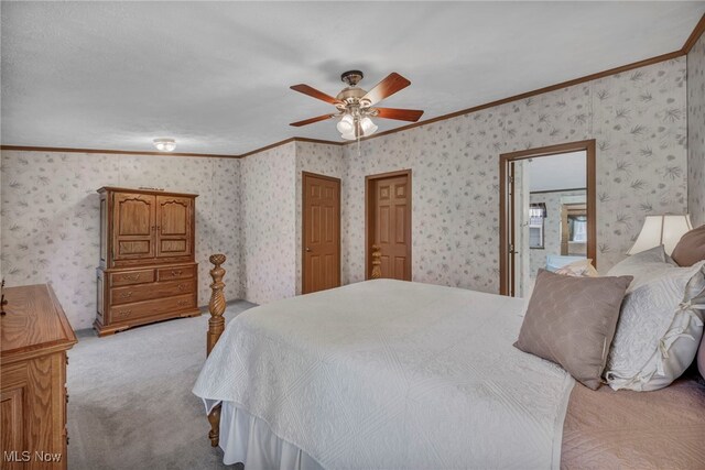 carpeted bedroom featuring ceiling fan, ornamental molding, and wallpapered walls
