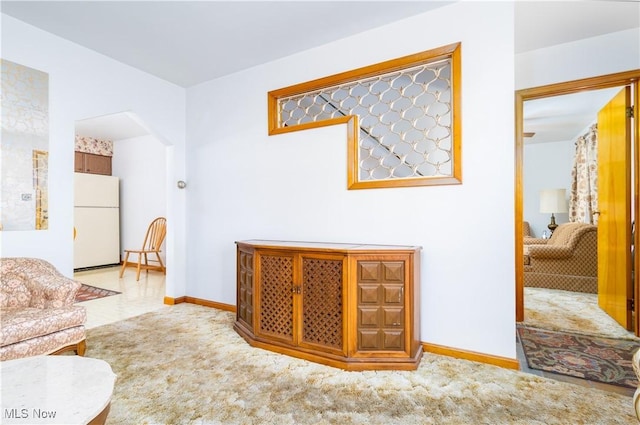 living room with carpet flooring and baseboards