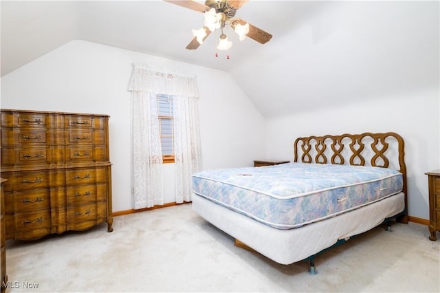 carpeted bedroom with baseboards, ceiling fan, and vaulted ceiling