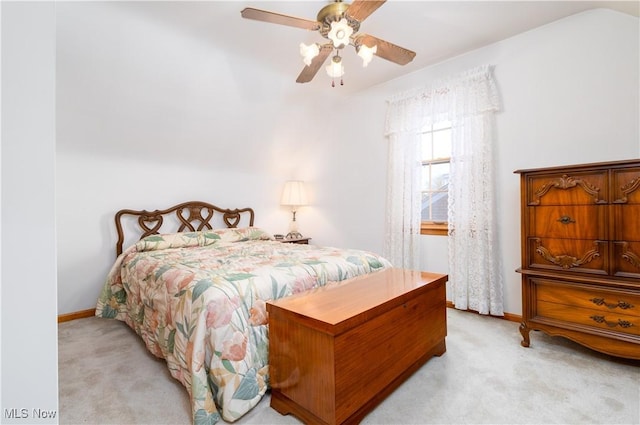 bedroom with baseboards, a ceiling fan, and light colored carpet