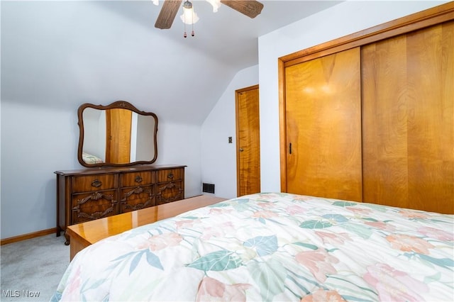 carpeted bedroom with ceiling fan, baseboards, and lofted ceiling