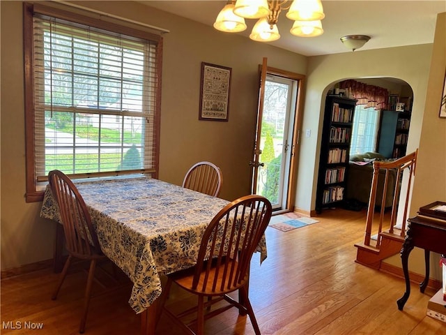 dining area featuring a chandelier, a healthy amount of sunlight, and light wood-type flooring
