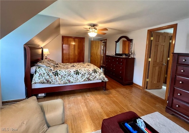 bedroom featuring baseboards, ceiling fan, and wood finished floors