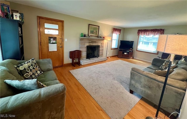 living area featuring a fireplace and light wood-type flooring