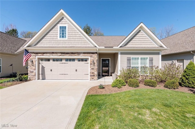 view of front of house with a garage, stone siding, a front yard, and concrete driveway