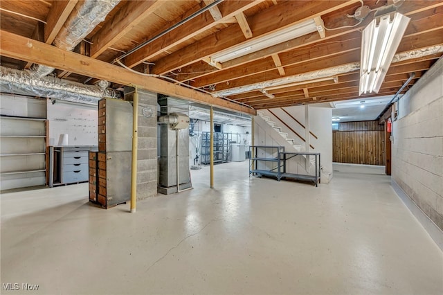 unfinished basement with washer / dryer and stairway