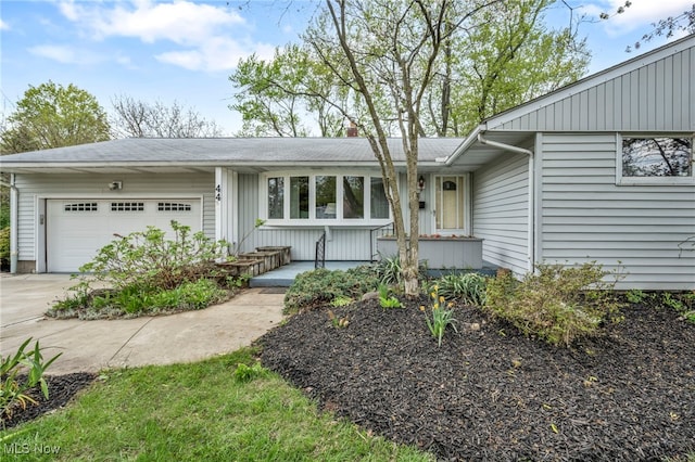 ranch-style house featuring concrete driveway and a garage