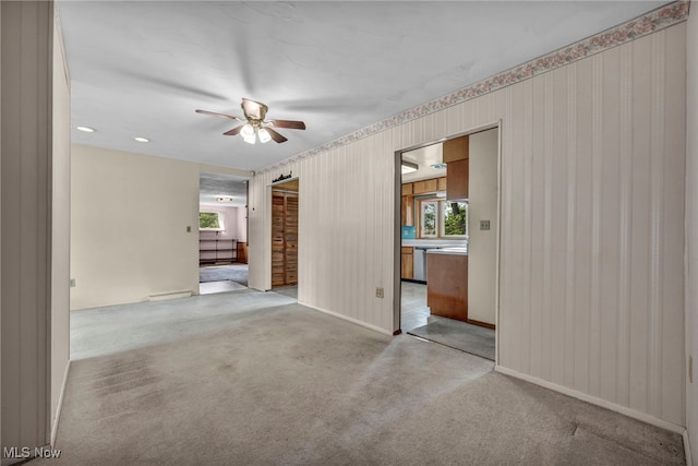 unfurnished room featuring baseboards, a ceiling fan, light carpet, and wallpapered walls