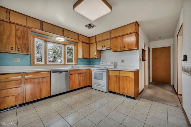 kitchen with light countertops, dishwasher, brown cabinetry, and white electric range