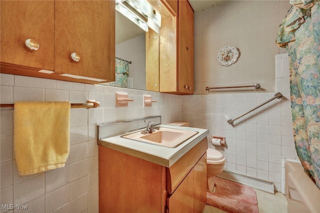 full bath featuring tile walls, baseboard heating, vanity, toilet, and shower / bathtub combination with curtain