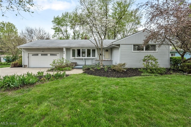 single story home featuring a garage, a front lawn, and driveway