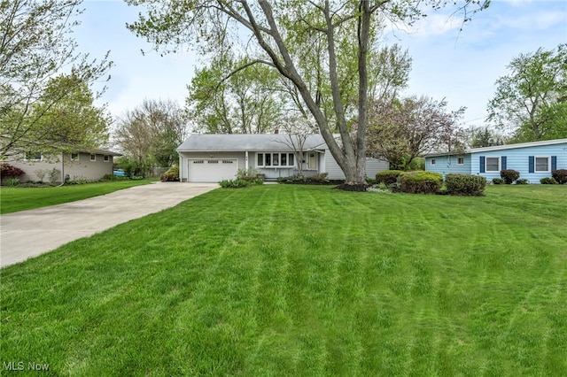 ranch-style house featuring a garage, concrete driveway, and a front yard