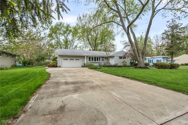 single story home featuring an attached garage, driveway, and a front yard