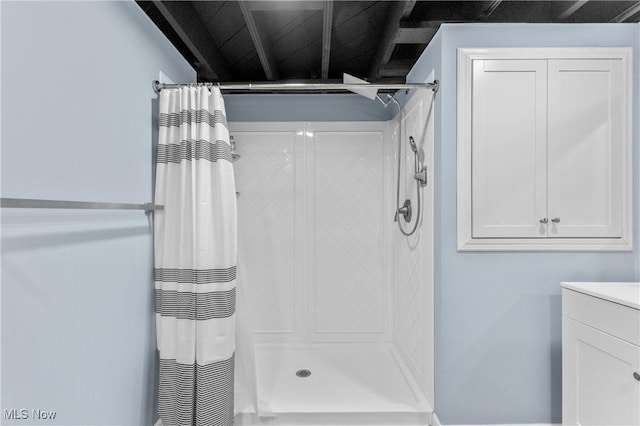 bathroom with vanity and a stall shower
