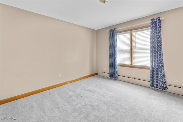 spare room with carpet floors and baseboards