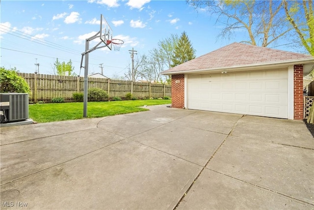 detached garage featuring fence and cooling unit