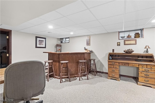 home office with a bar, recessed lighting, carpet, and a paneled ceiling
