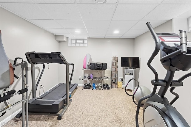 exercise room featuring baseboards, recessed lighting, and a paneled ceiling