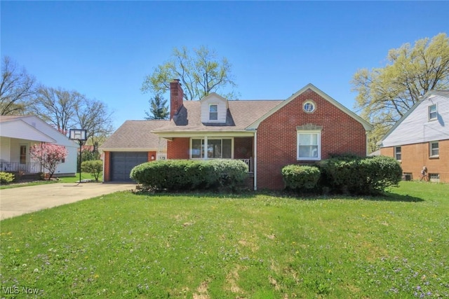 view of front of home featuring a front lawn, a chimney, brick siding, an attached garage, and driveway