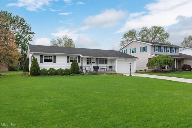 view of front of home featuring an attached garage, concrete driveway, a porch, and a front lawn