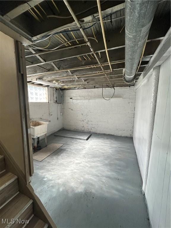 basement featuring a sink and stairs