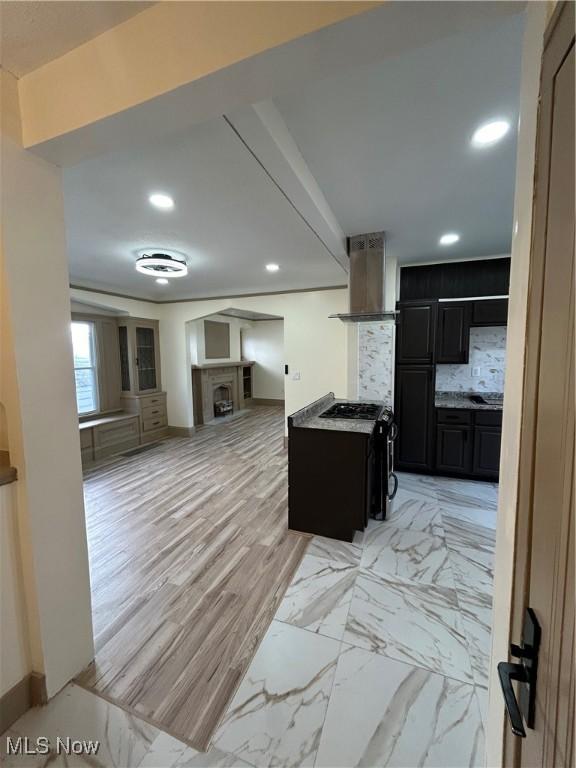hall with recessed lighting, baseboards, and marble finish floor