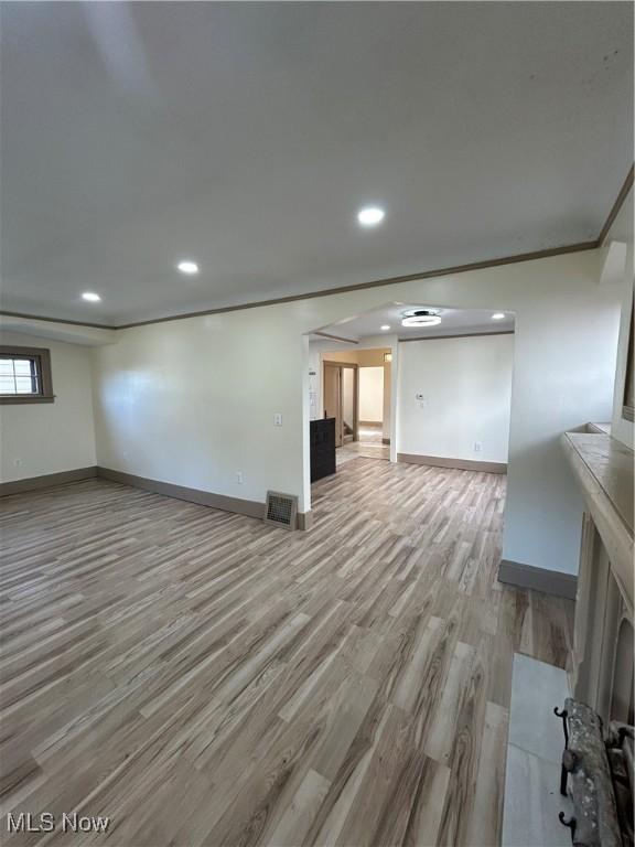 unfurnished living room with baseboards, recessed lighting, wood finished floors, and visible vents