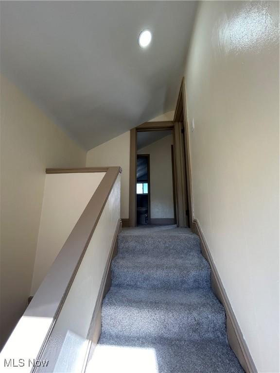 stairs featuring carpet flooring, recessed lighting, and lofted ceiling