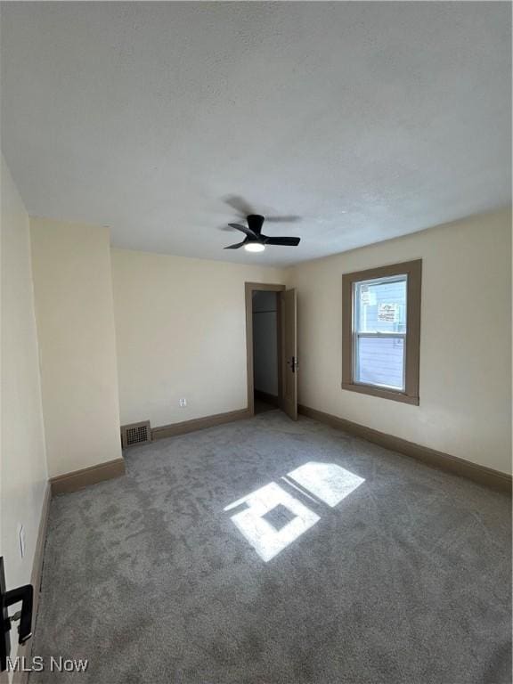 unfurnished bedroom with carpet floors, baseboards, and visible vents