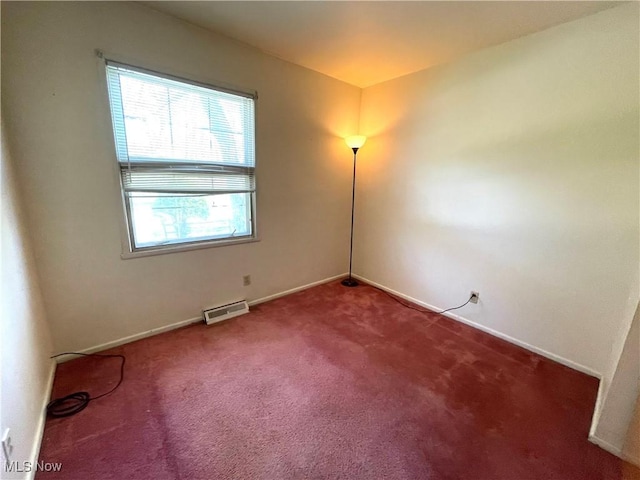 carpeted spare room featuring baseboards and visible vents