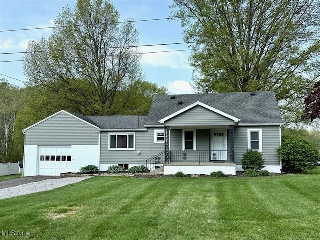 single story home with a porch, a front lawn, roof with shingles, and a garage