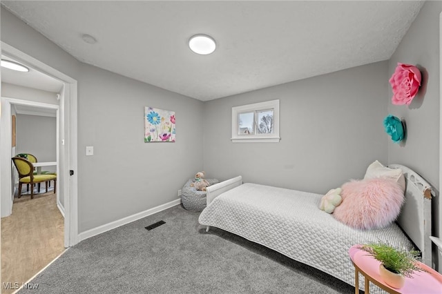 bedroom featuring visible vents, carpet flooring, and baseboards