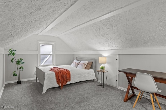 carpeted bedroom featuring a textured ceiling, baseboards, and lofted ceiling