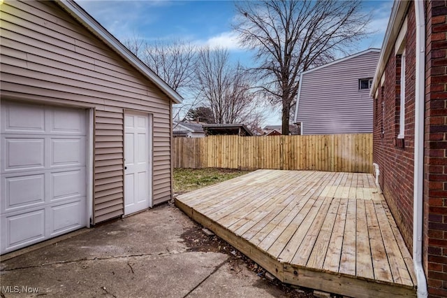 wooden terrace with a fenced backyard