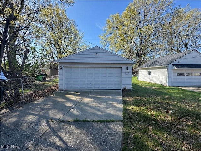 detached garage featuring fence