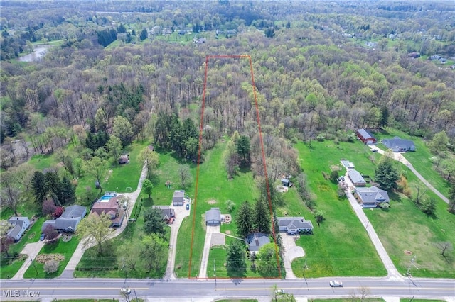 drone / aerial view with a wooded view